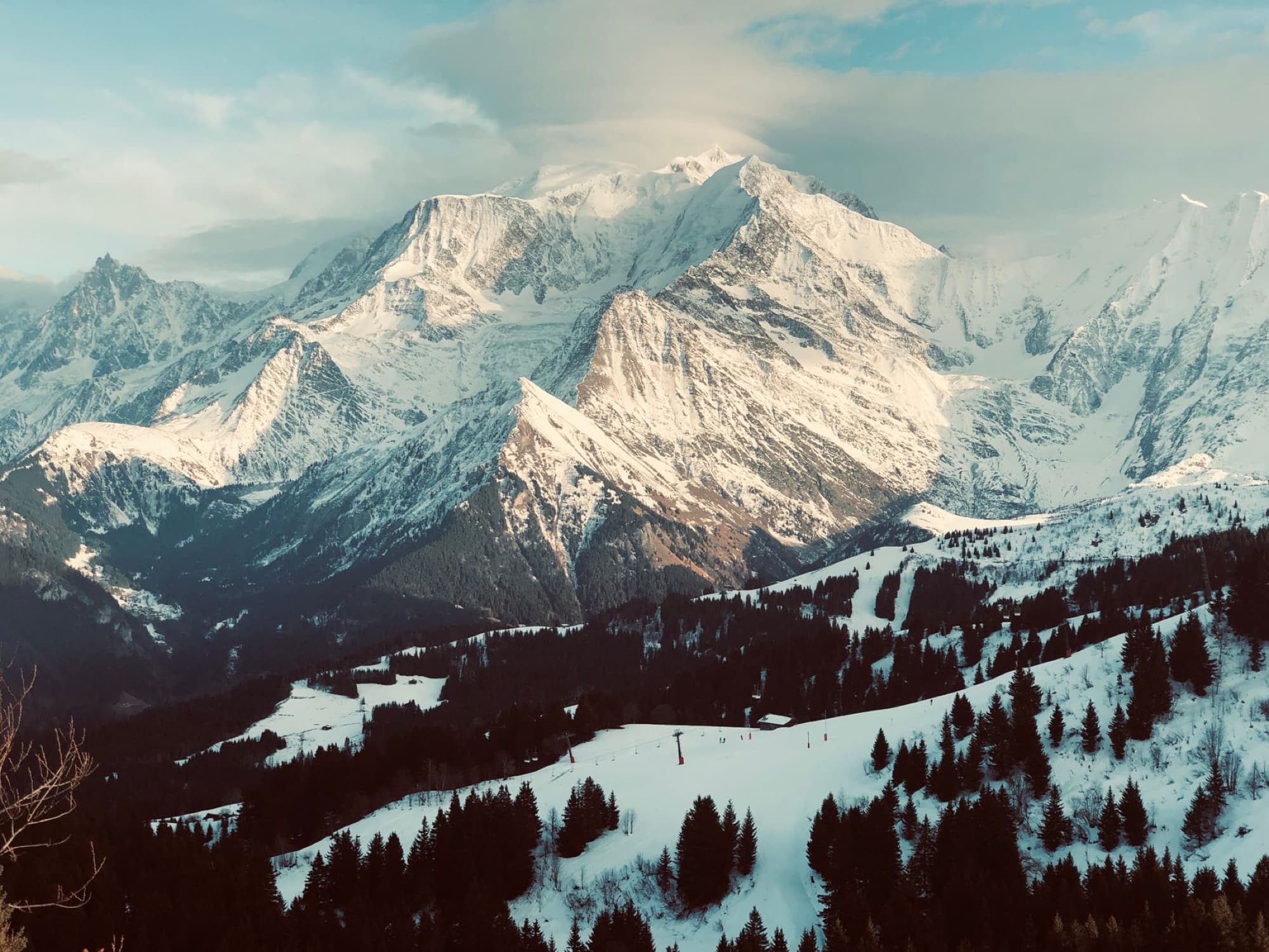 Breathtaking snowy mountain landscape of the French Alps at sunset, perfect for winter travel inspiration.