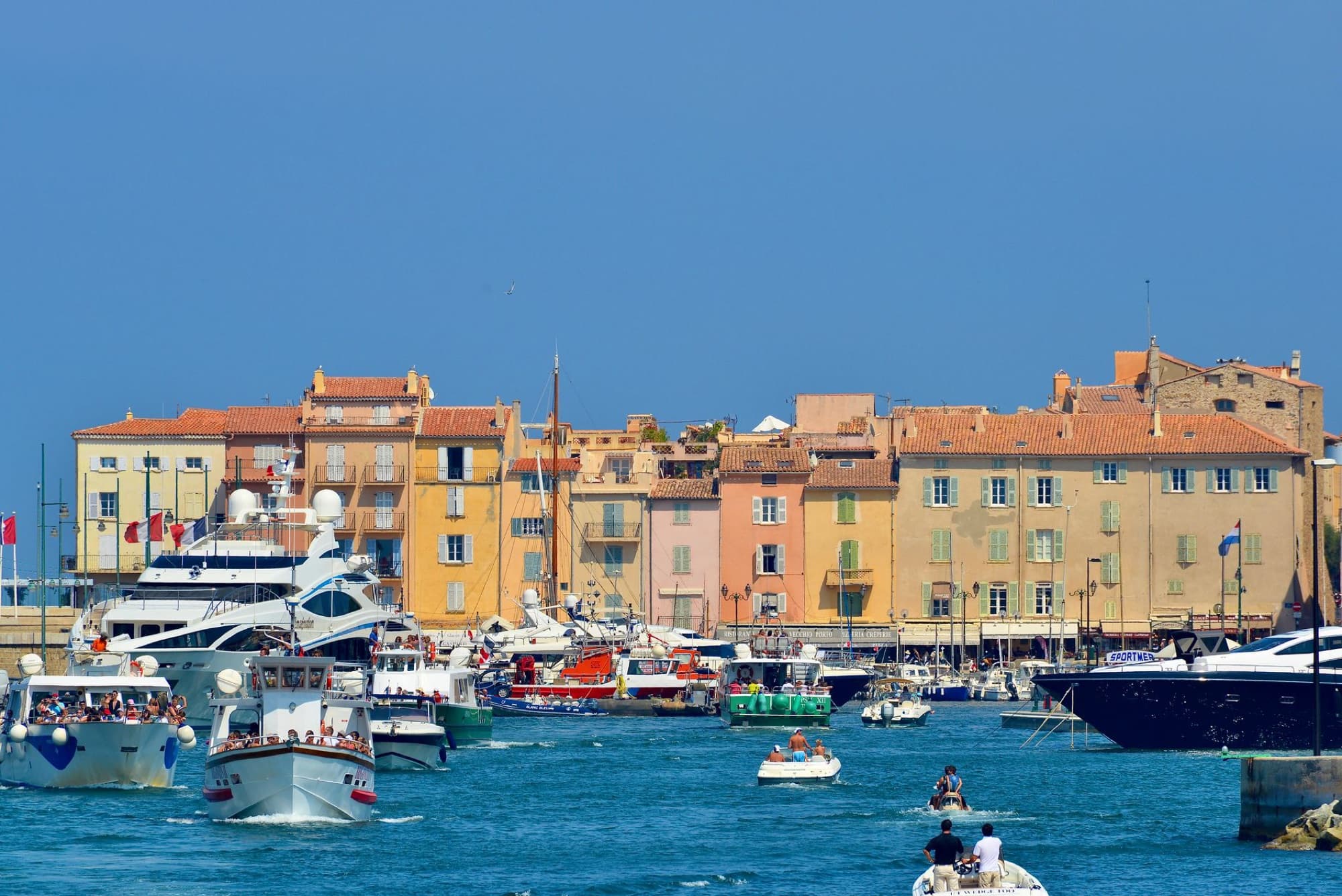 Elegant yachts in the vibrant harbor of Saint-Tropez under a clear blue sky.