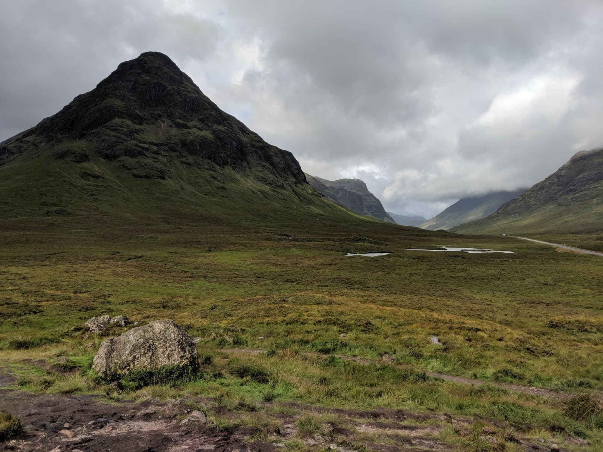Scenic view of the Scottish Highlands at Altnafeadh with mountains and a grassy landscape.
