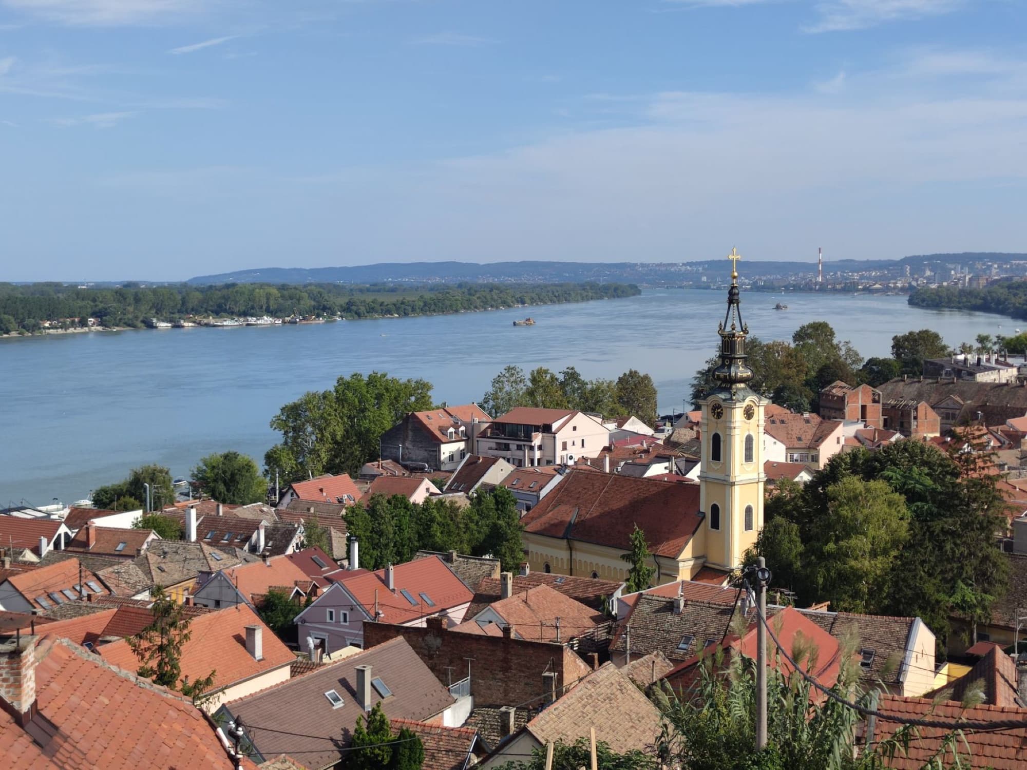 Beautiful aerial view of Zemun, Serbia with the Danube River and historic church tower.