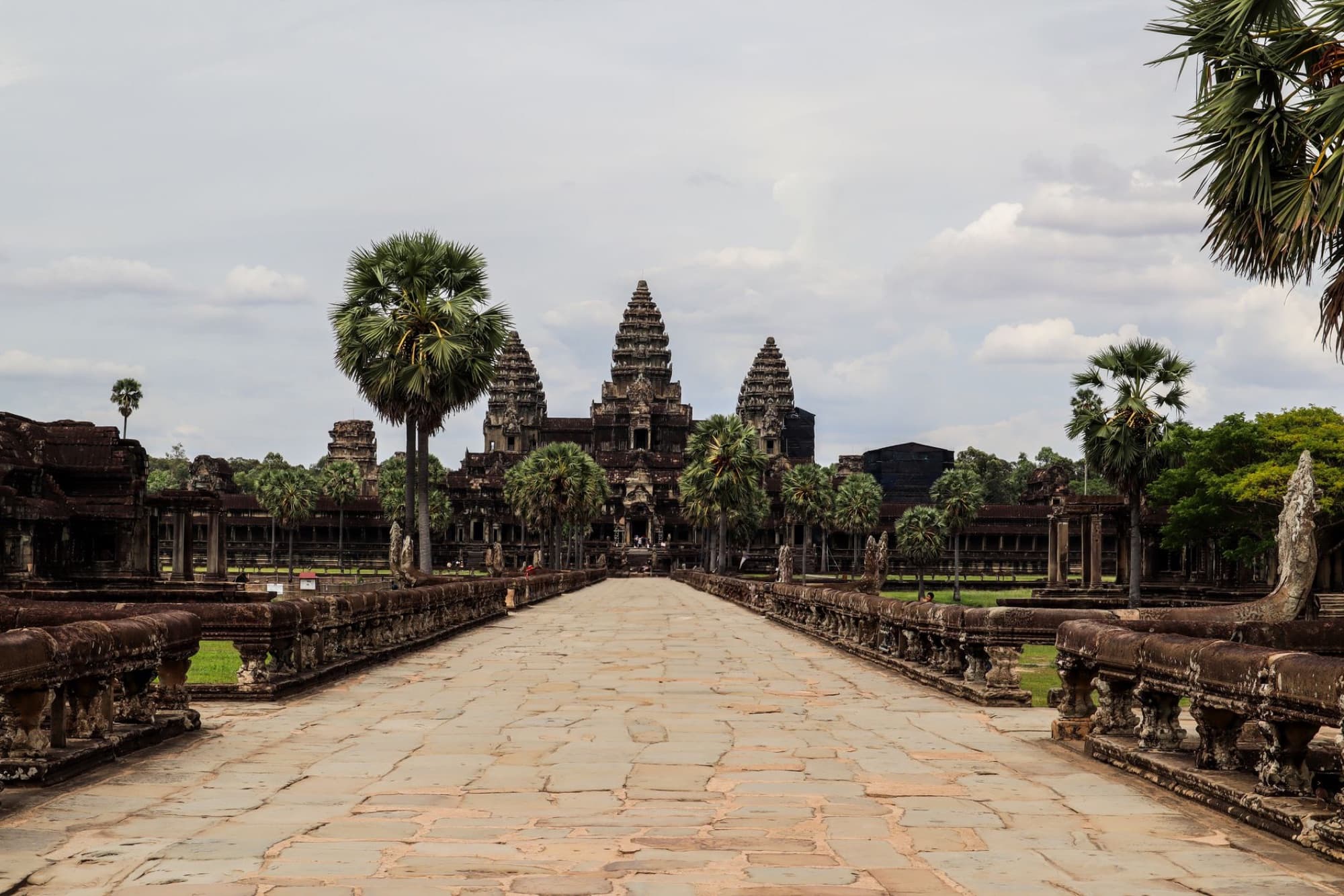 Angkor Wat temple in Siem Reap, Cambodia, showcasing ancient Khmer architecture amidst a tropical setting.