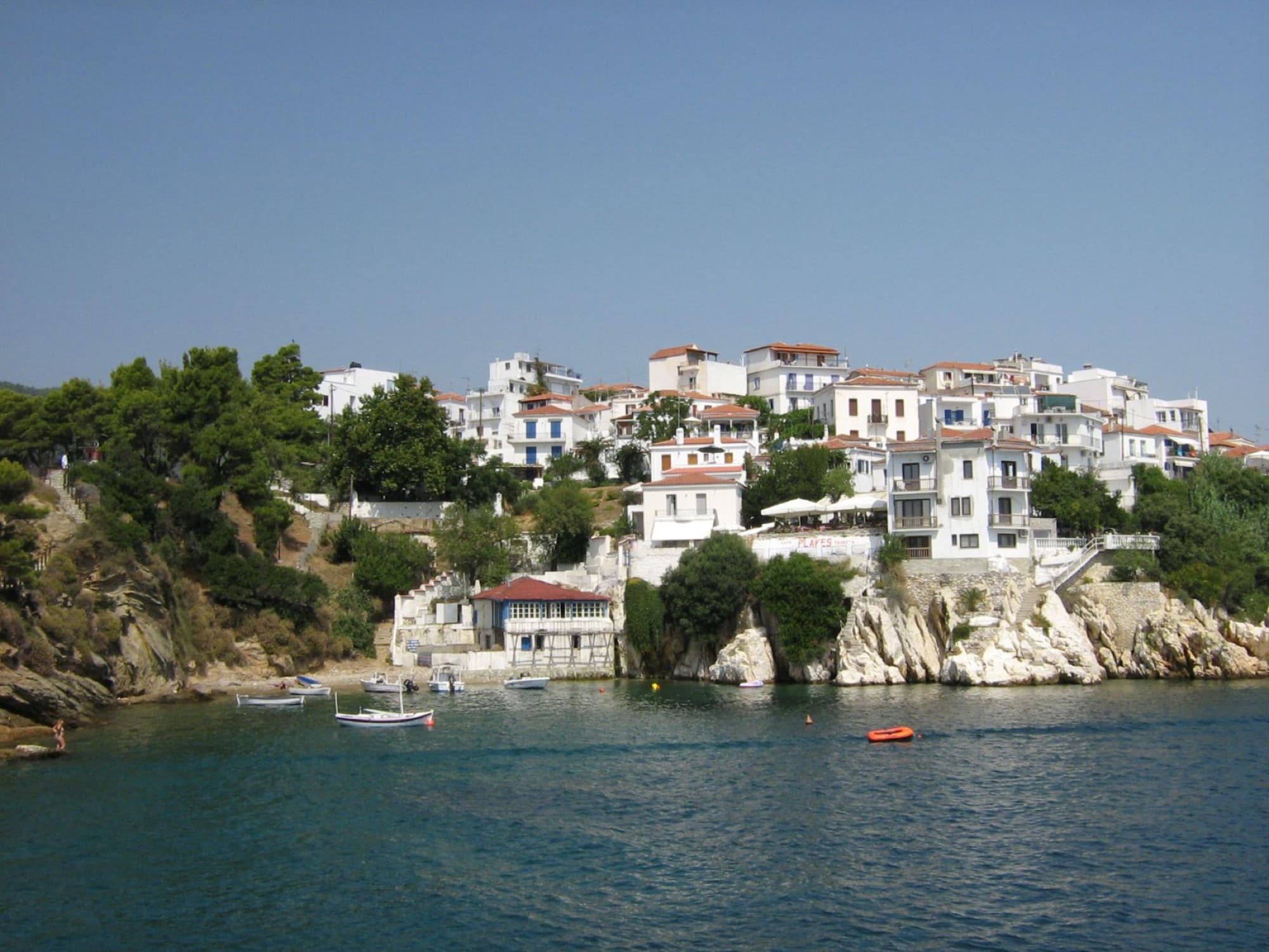 Discover the picturesque traditional architecture of Skiathos, Greece, by the beautiful Aegean Sea.