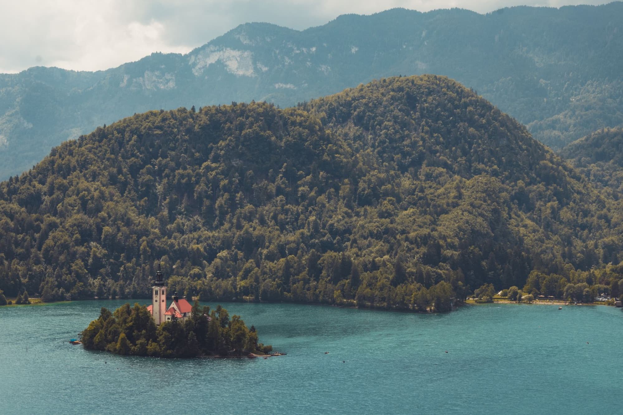 Captivating aerial view of Lake Bled with lush green mountains and the iconic island in Slovenia.