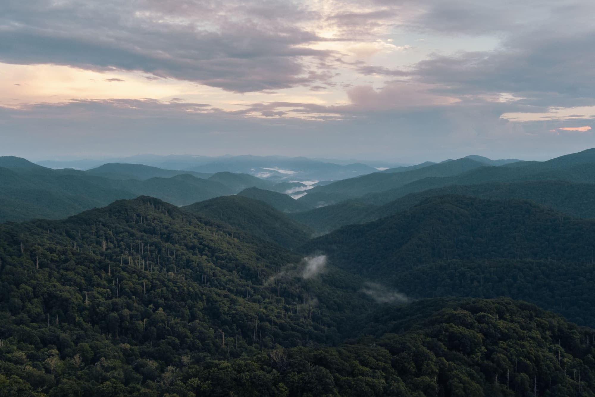 A breathtaking aerial view of the misty Great Smoky Mountains at sunrise in Gatlinburg, Tennessee.