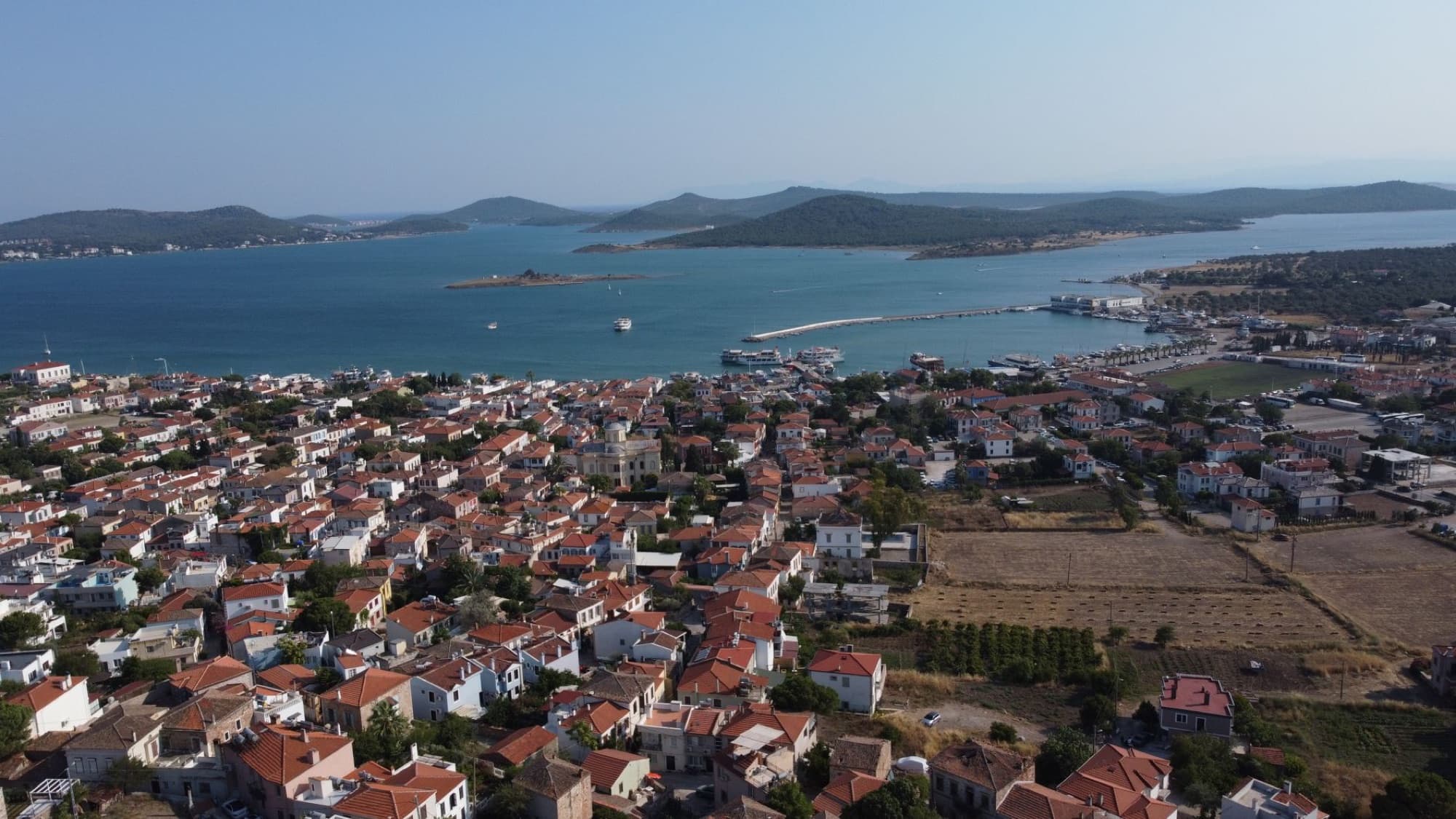 Captivating aerial view of Ayvalık showing the scenic coastline and vibrant cityscape in Türkiye.