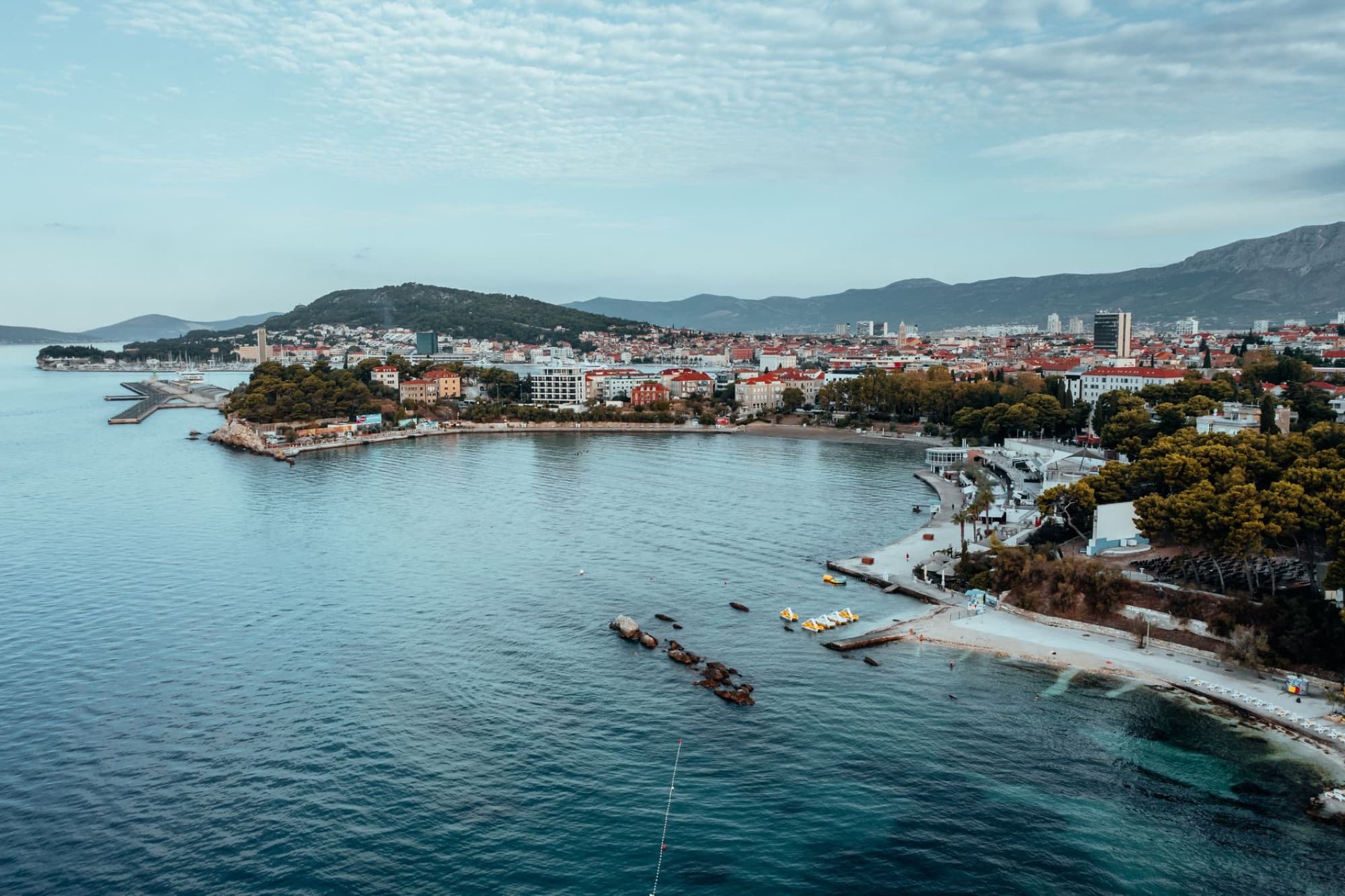 Drone shot of Split's beautiful coastline, featuring a scenic view of the city and the Adriatic Sea.