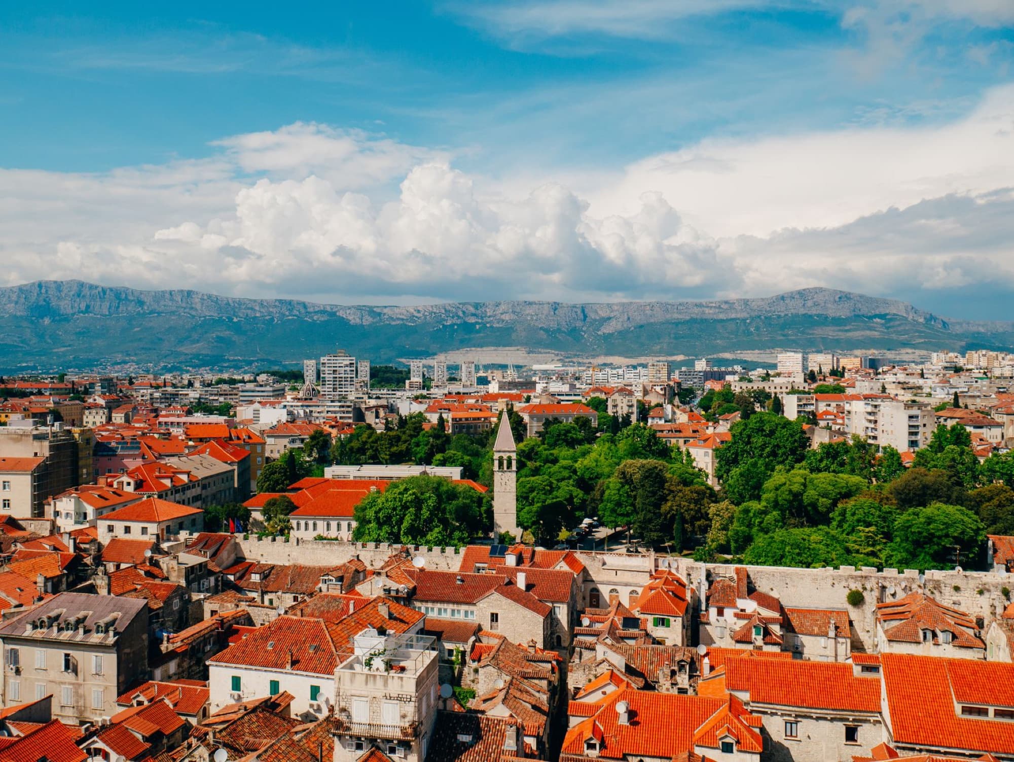 Aerial view of Split, Croatia, featuring red rooftops and the Cathedral of Saint Domnius.