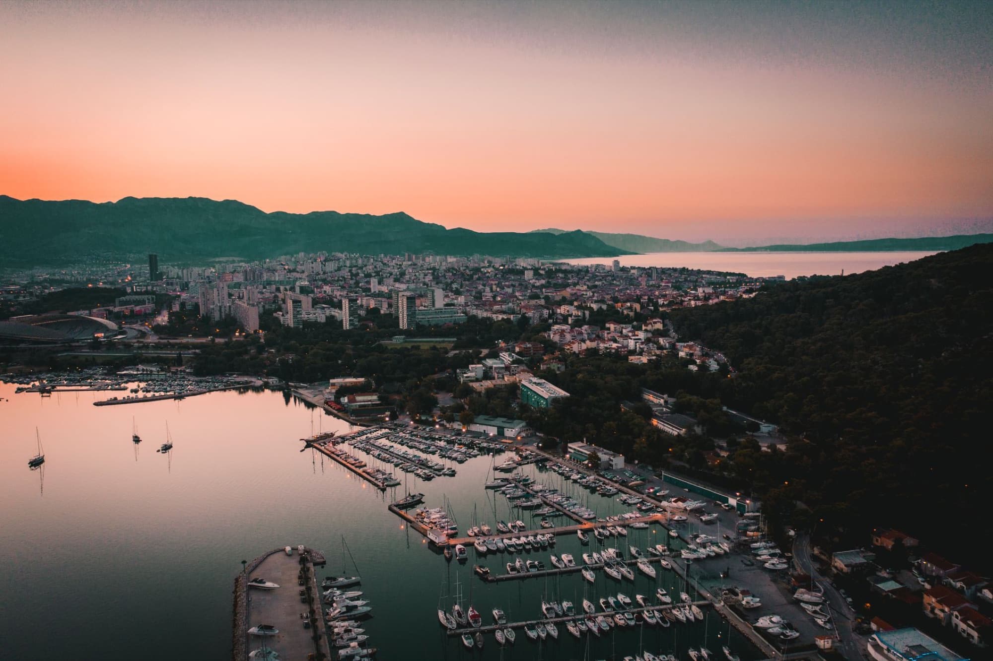 A stunning aerial view of Split Harbor at sunset, showcasing the marina and cityscape.