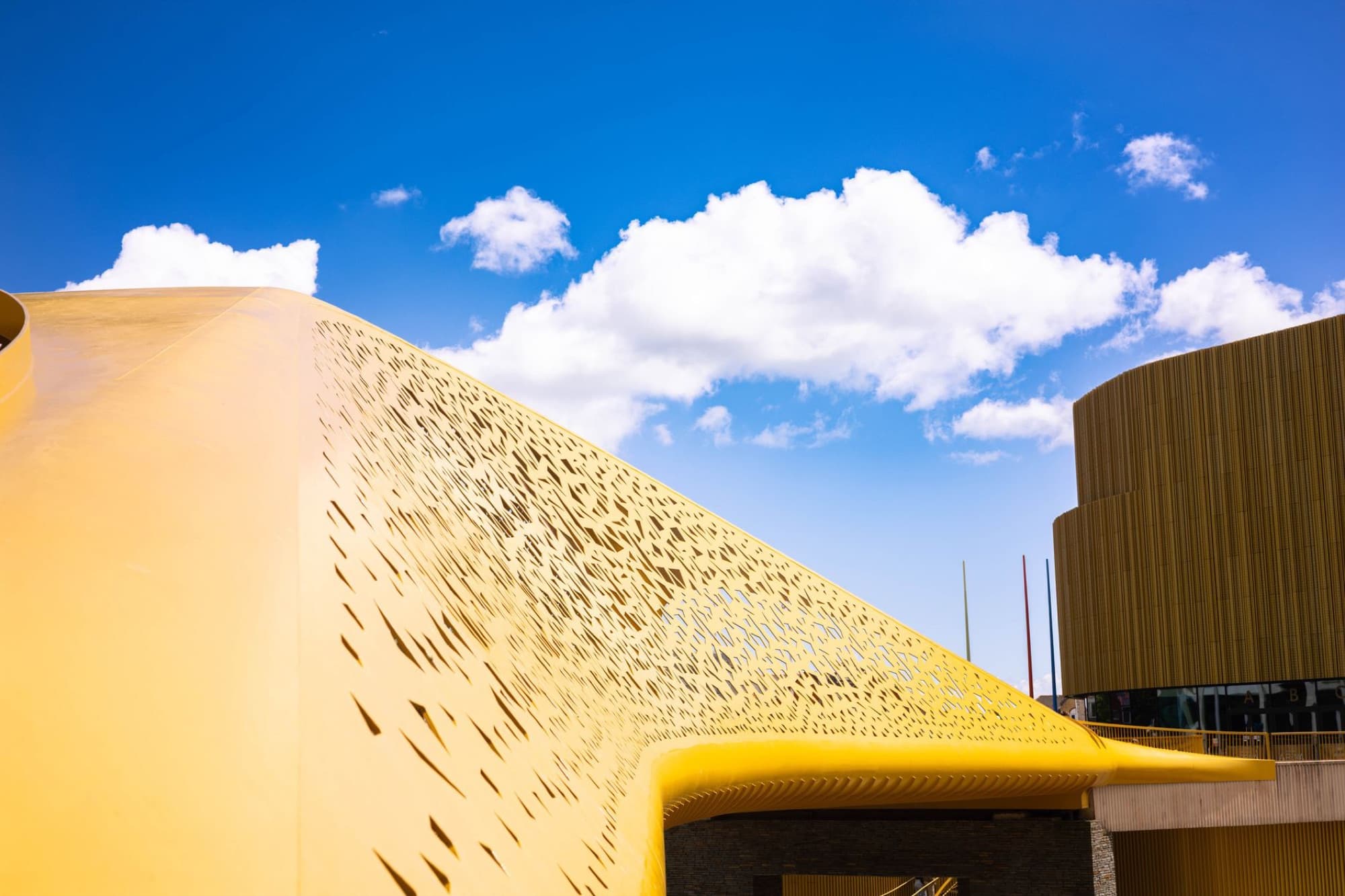 Architectural detail of a modern structure in Swansea, Wales, against a bright blue sky.