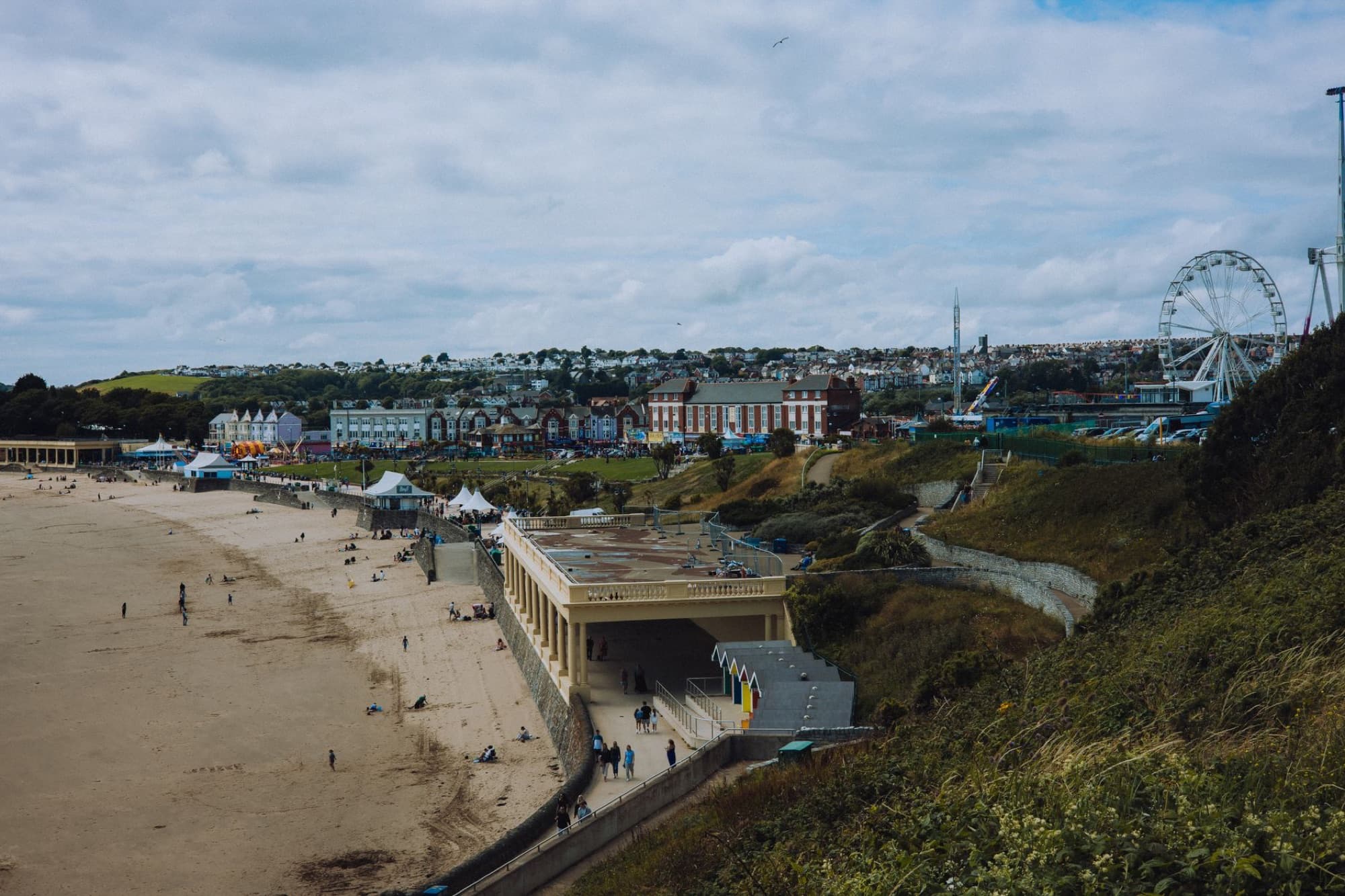 Scenic aerial view of Cardiff's beachfront area with a Ferris wheel, capturing urban landscape and seaside charm.