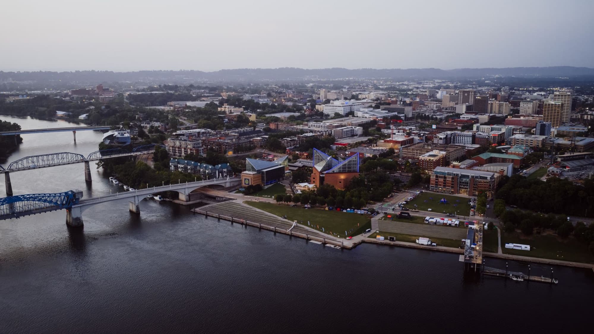 Scenic aerial view of Chattanooga, Tennessee, with river and city skyline at dusk.