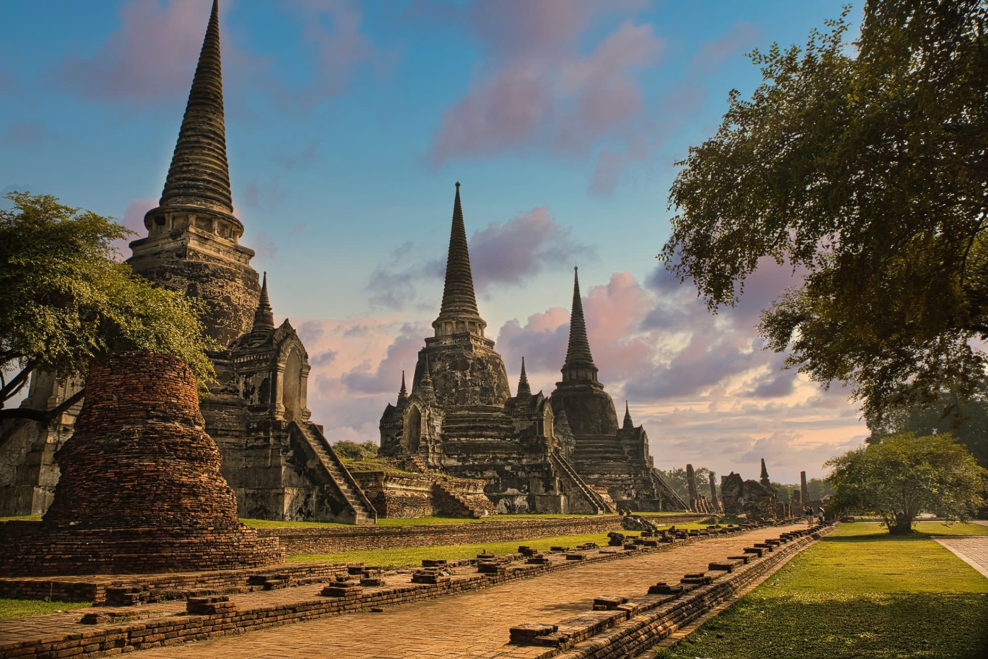 Explore the stunning ancient temples of Ayutthaya in Thailand, showcasing historical architecture and serene beauty at sunset.