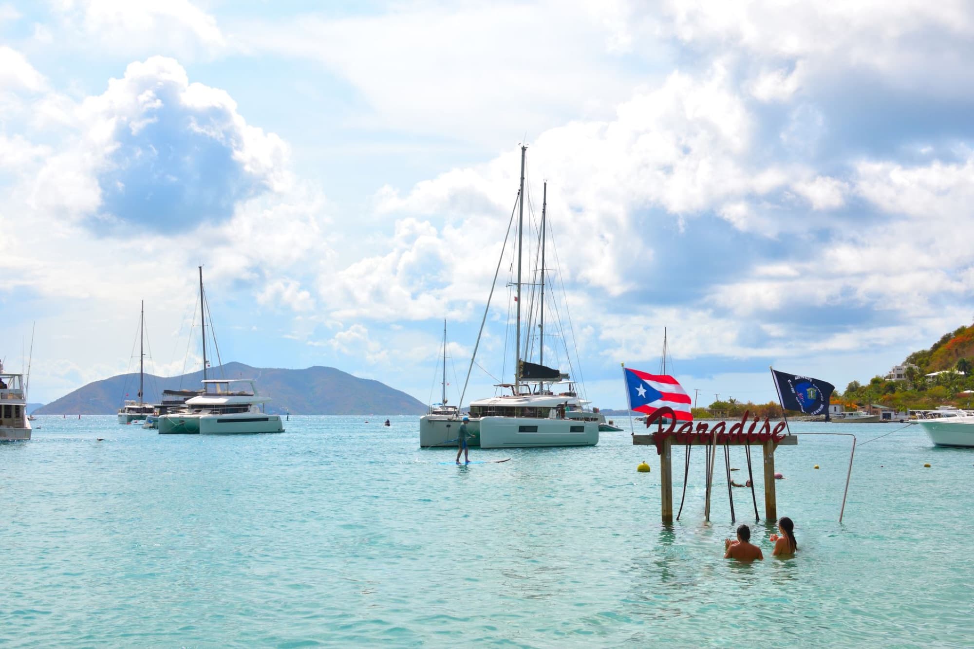 Idyllic coastal setting in Tortola, British Virgin Islands, featuring catamarans and turquoise waters.