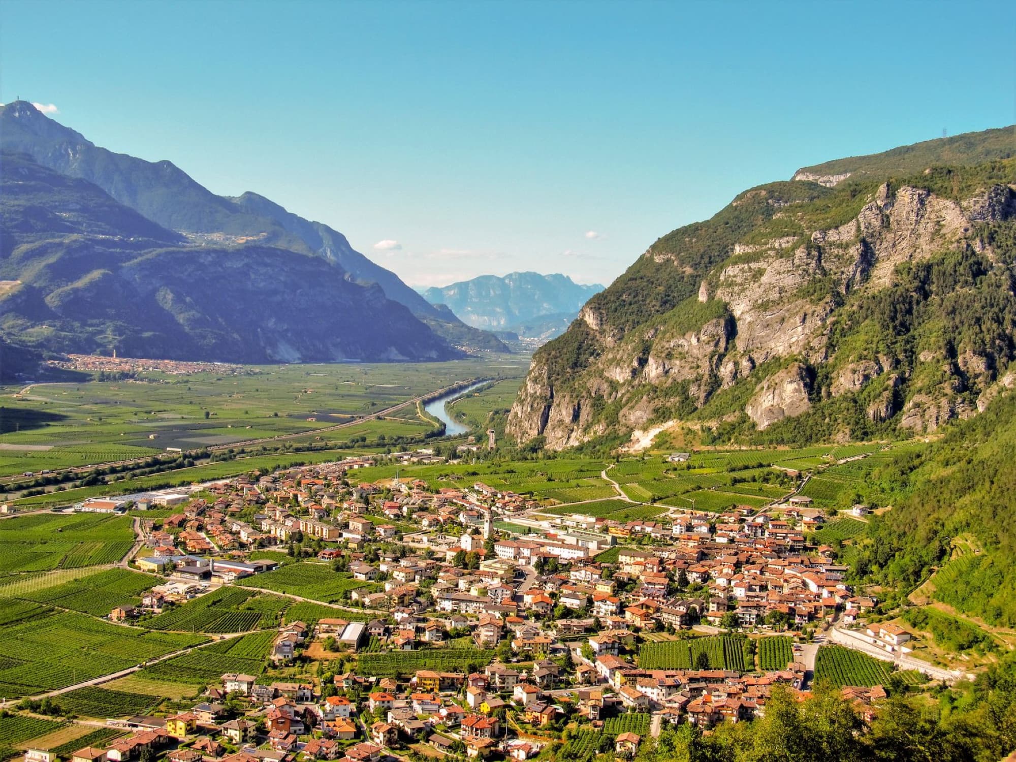 Scenic aerial view of Besenello town nestled in the mountains of Trentino, Italy, during summer.