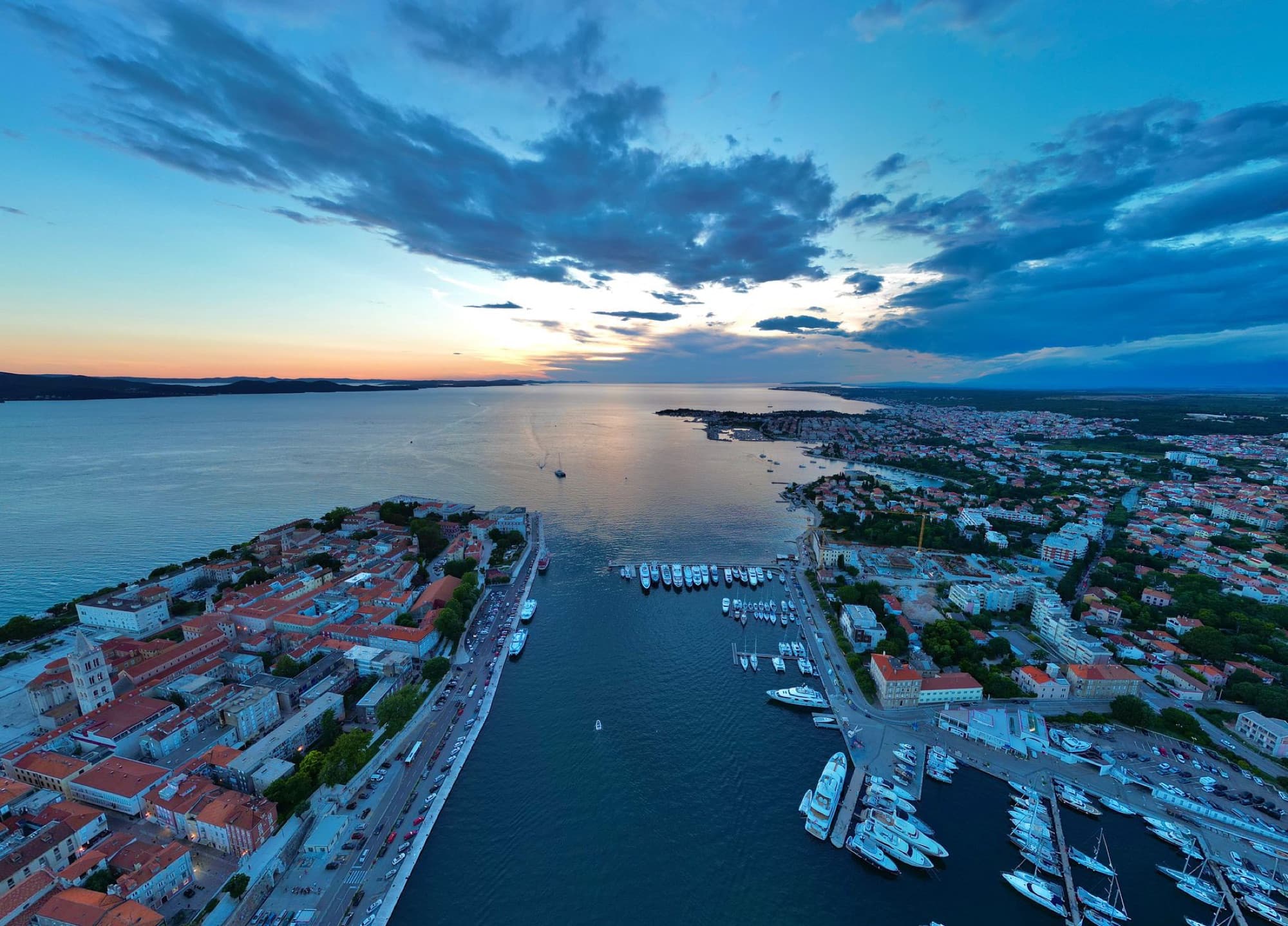 Stunning aerial capture of Zadar's picturesque harbor at sunset with vibrant skies.