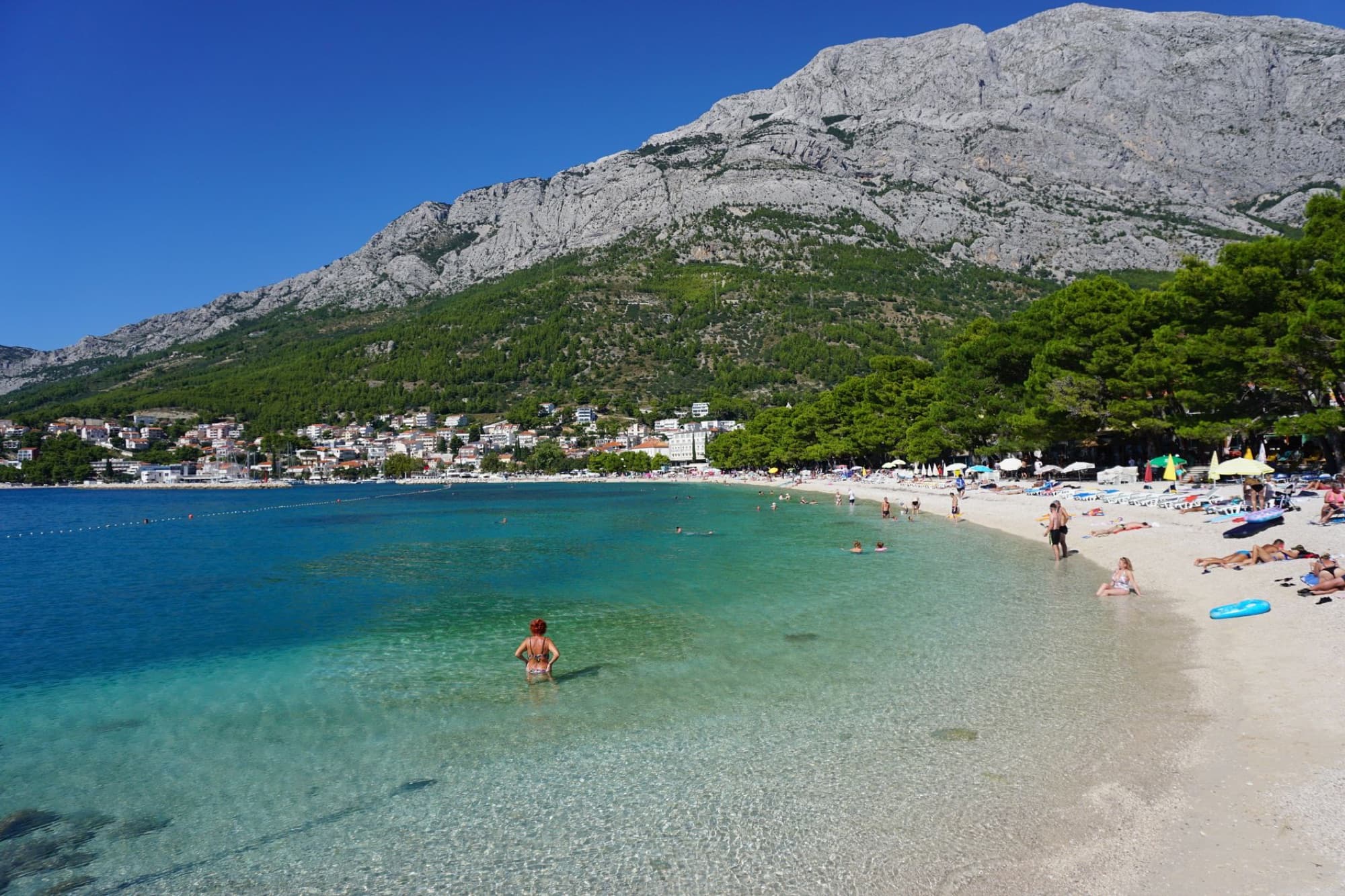 Baška Voda beach in Croatia, offering clear waters, scenic mountains, and a relaxing summer vibe.
