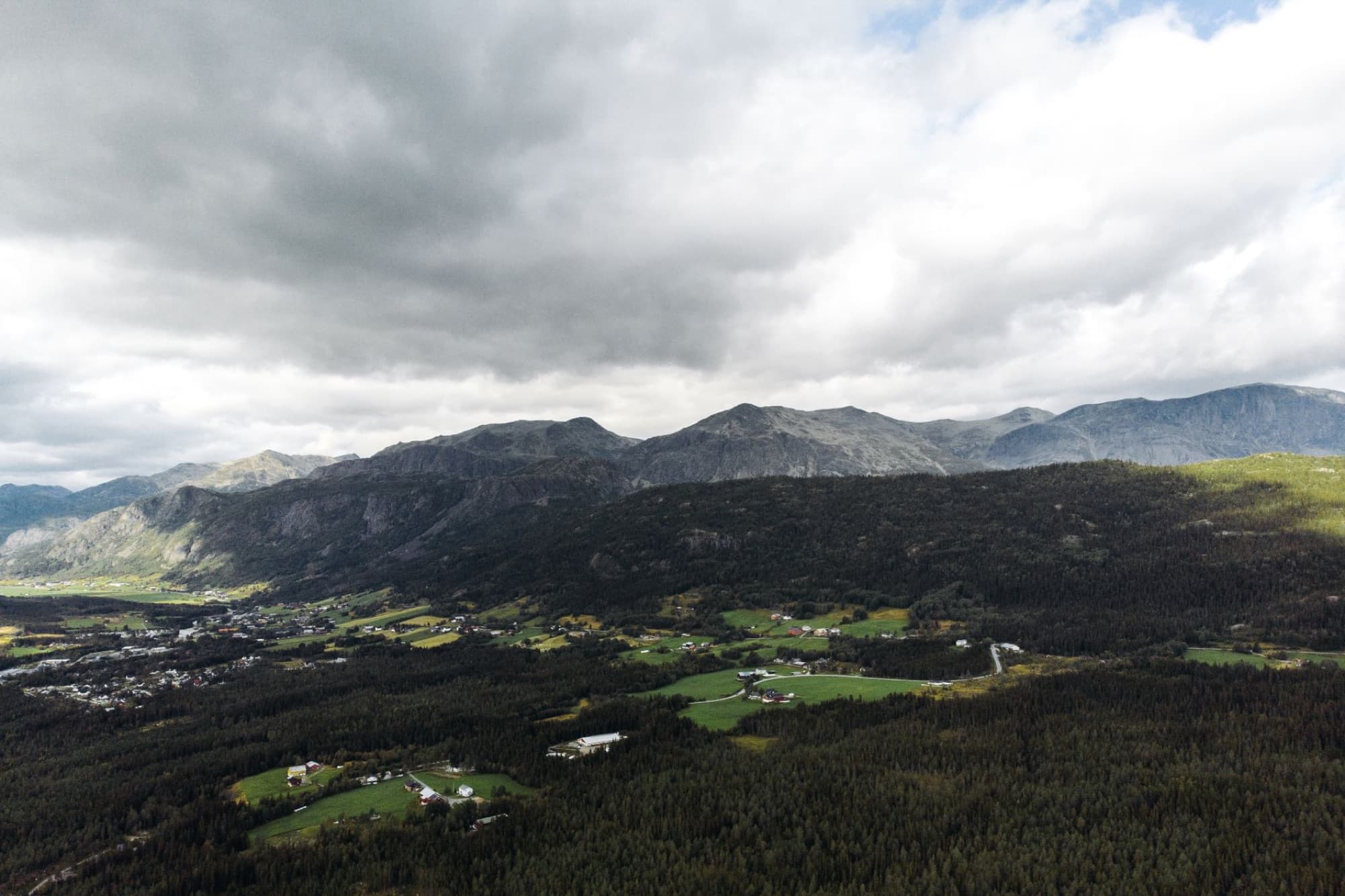 A breathtaking aerial view capturing the lush valley and mountains of Hemsedal, Viken, Norway under a cloudy sky.