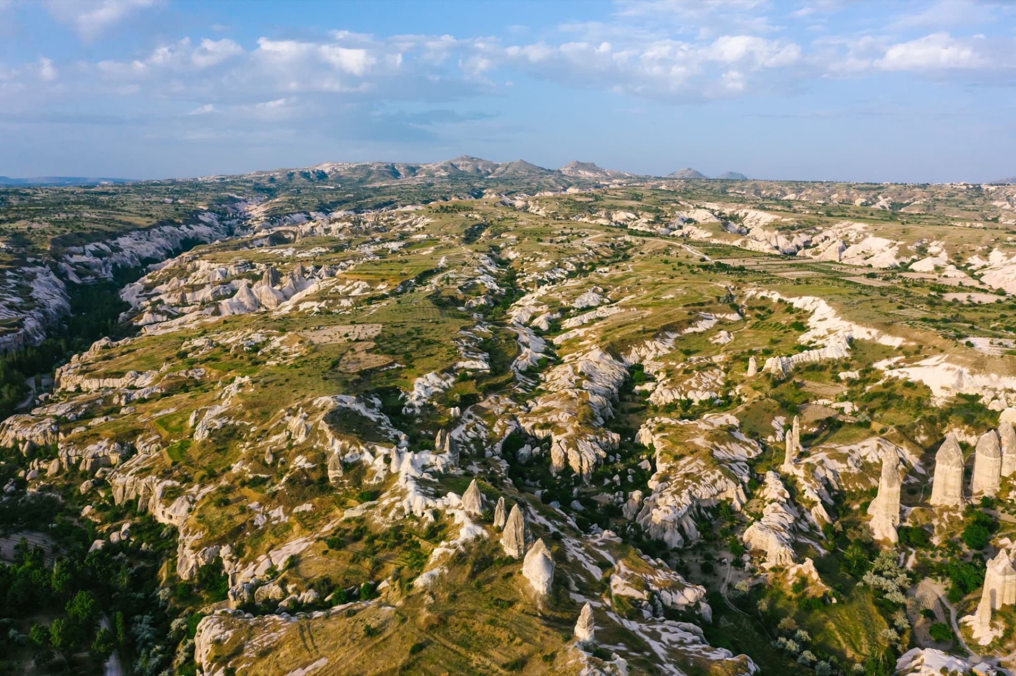 Explore the breathtaking aerial perspective of Cappadocia's iconic rock formations and scenic landscape.