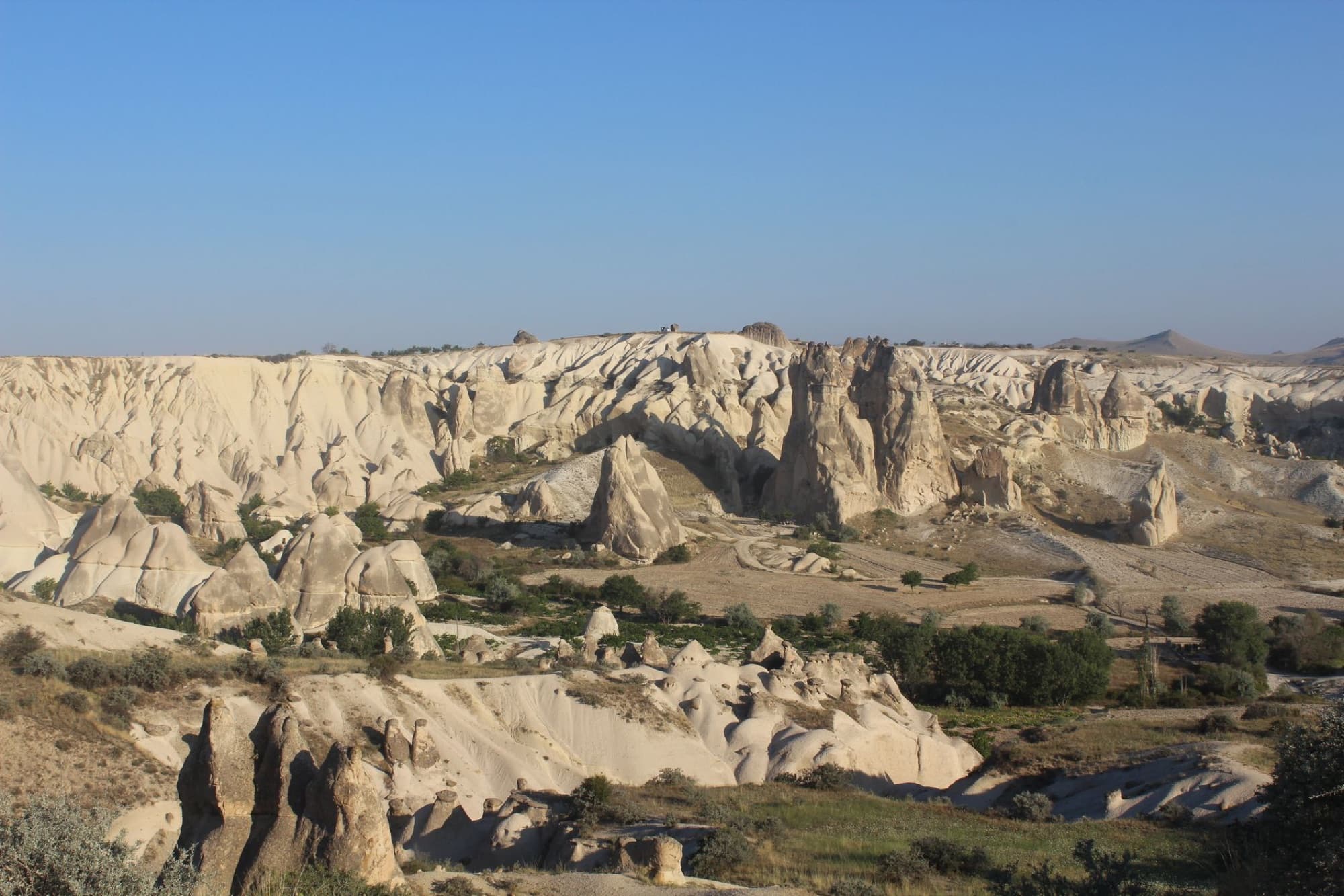 Stunning aerial view of Cappadocia's unique rock formations in a summer landscape.