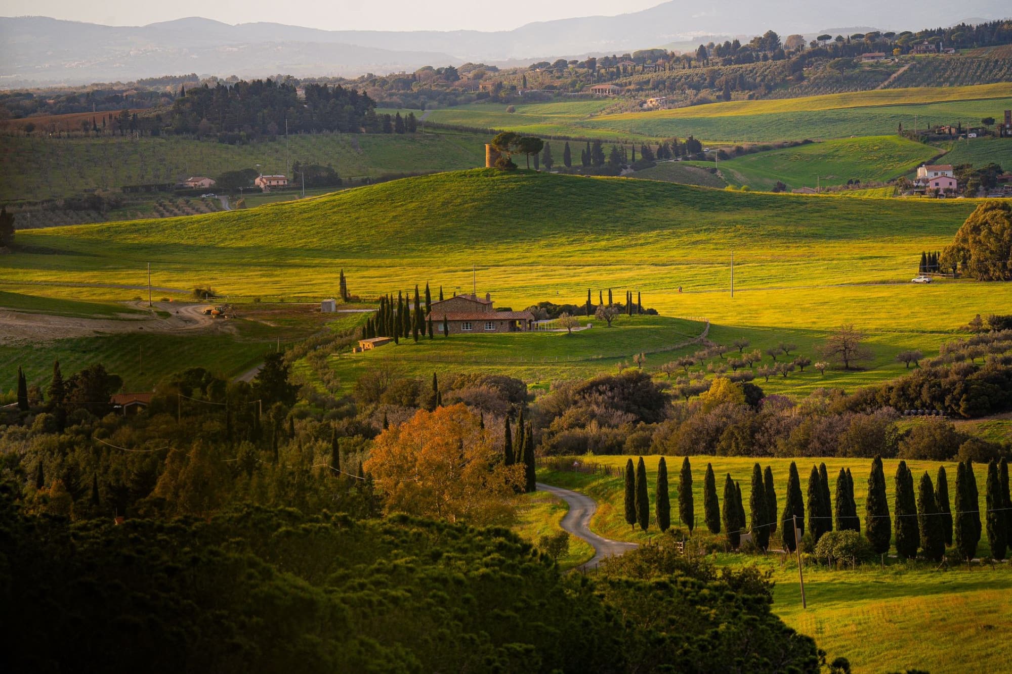 Breathtaking aerial view of the rolling hills in Tuscany, Italy, during sunset.