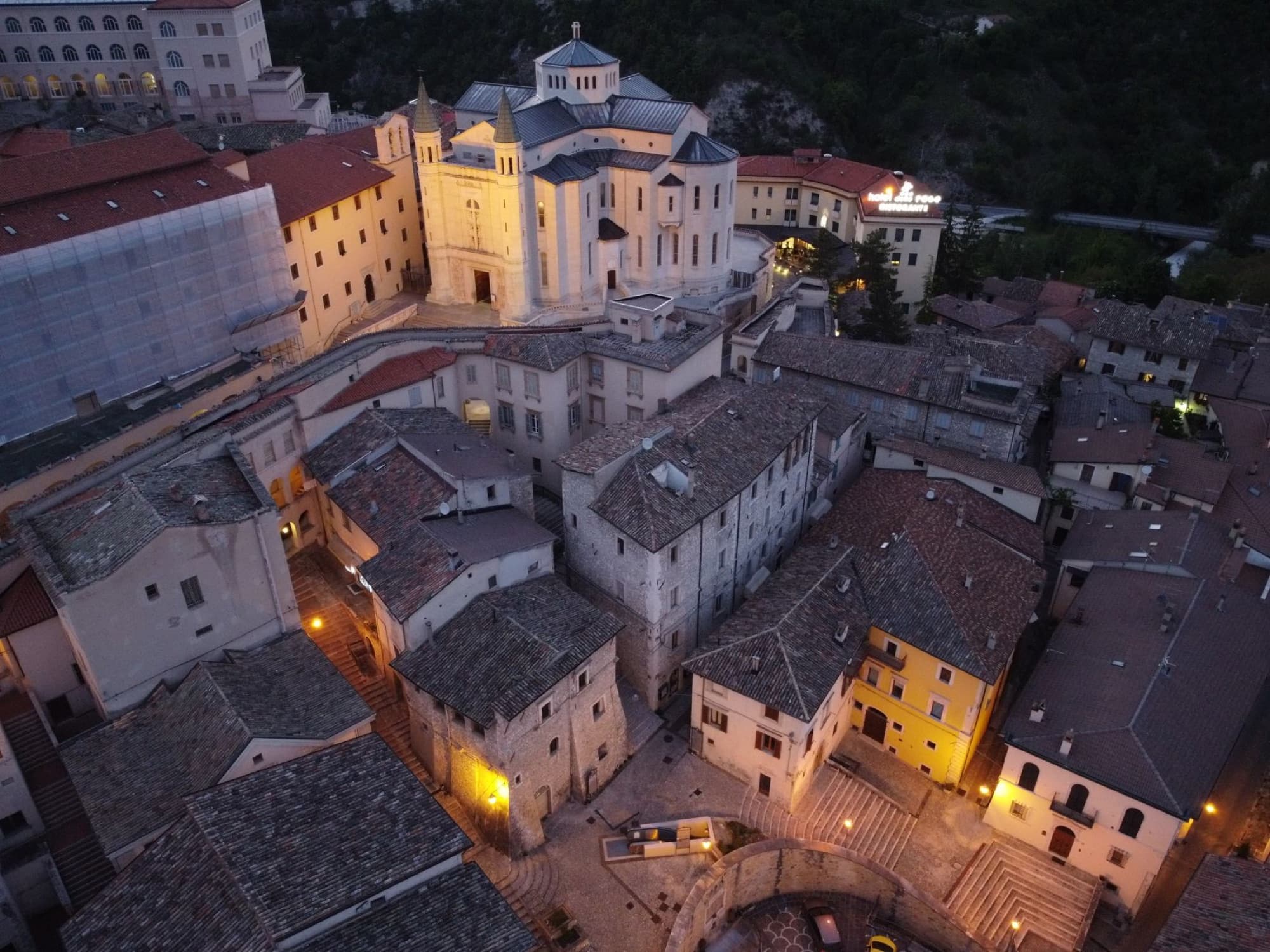 Stunning aerial view of Cascia's medieval architecture at dusk, capturing the serene Italian town in Umbria.