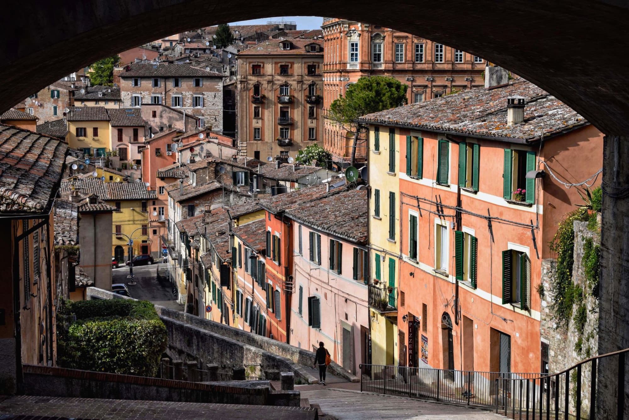 Explore the vibrant architecture and historic charm of Umbria's old town streets.