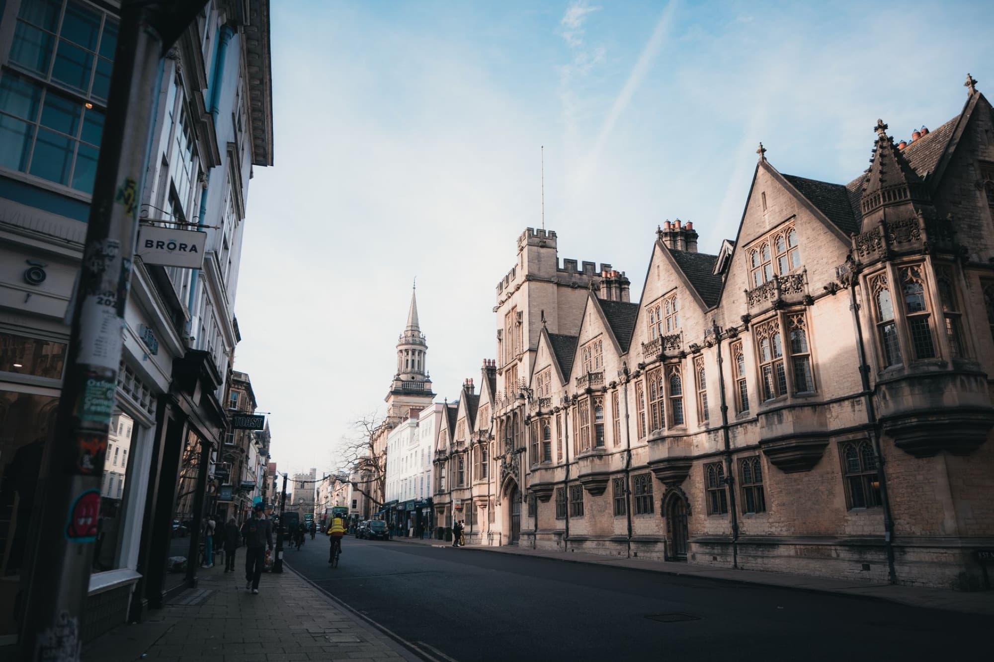 Captivating architectural view of a street in Oxford, England at sunrise, showcasing historic buildings.