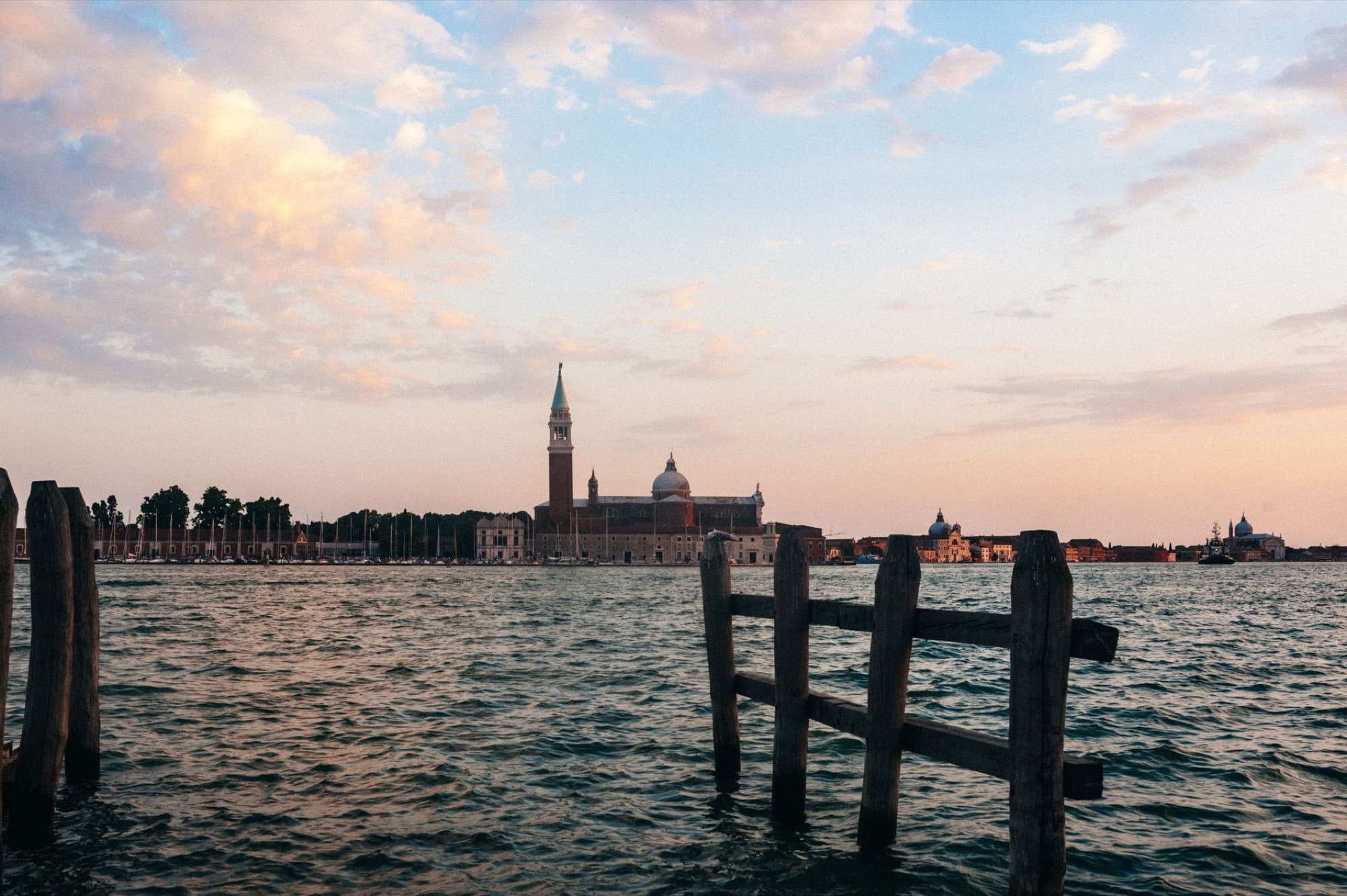 Scenic view of Venice's skyline featuring St. George's Church across the bay during sunset.