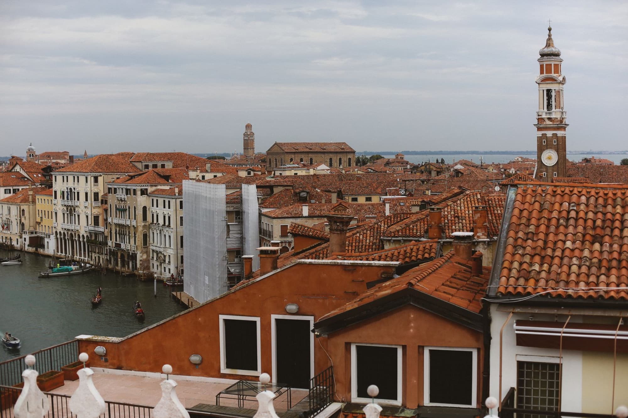Scenic aerial view of Venice showing canals and iconic terracotta rooftops.