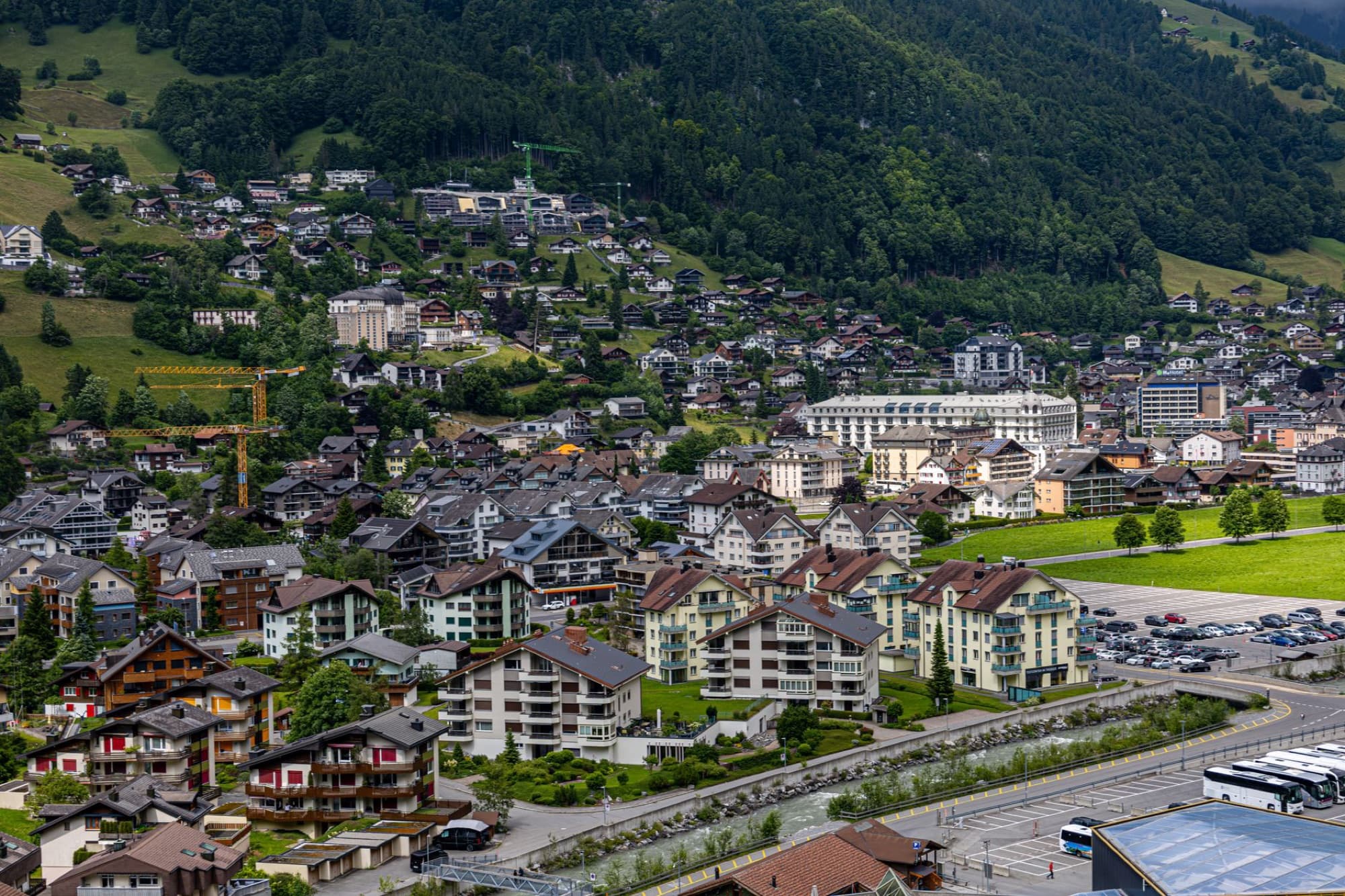 A beautiful aerial view of Engelberg, Switzerland showcasing charming houses and lush mountains.