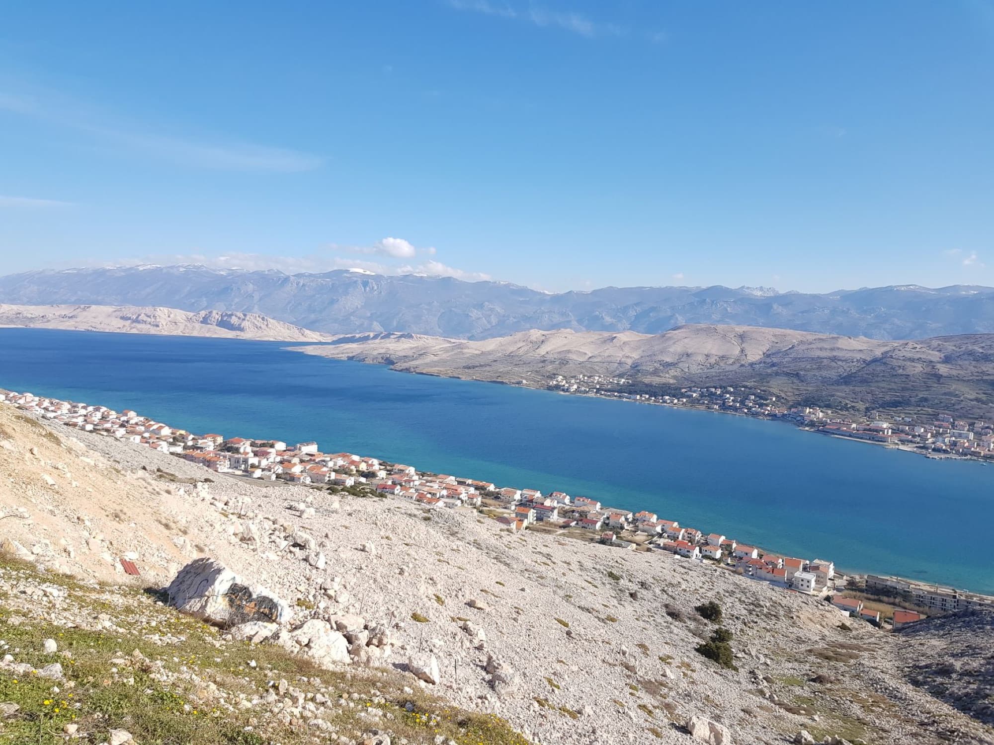Discover the breathtaking landscape of Pag Island, Croatia with clear blue waters and rugged mountains.
