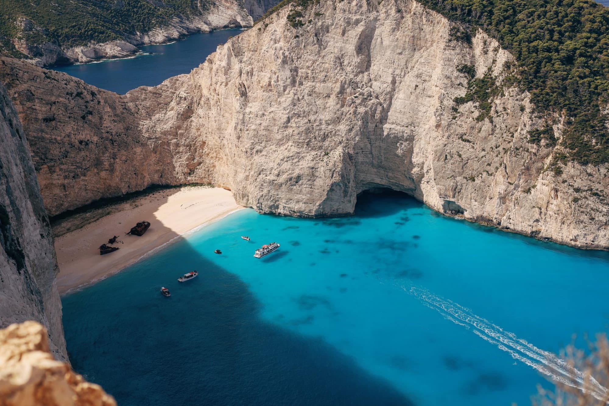 Stunning aerial view of Navagio Beach with crystal clear waters and scenic cliffs in Zakynthos, Greece.