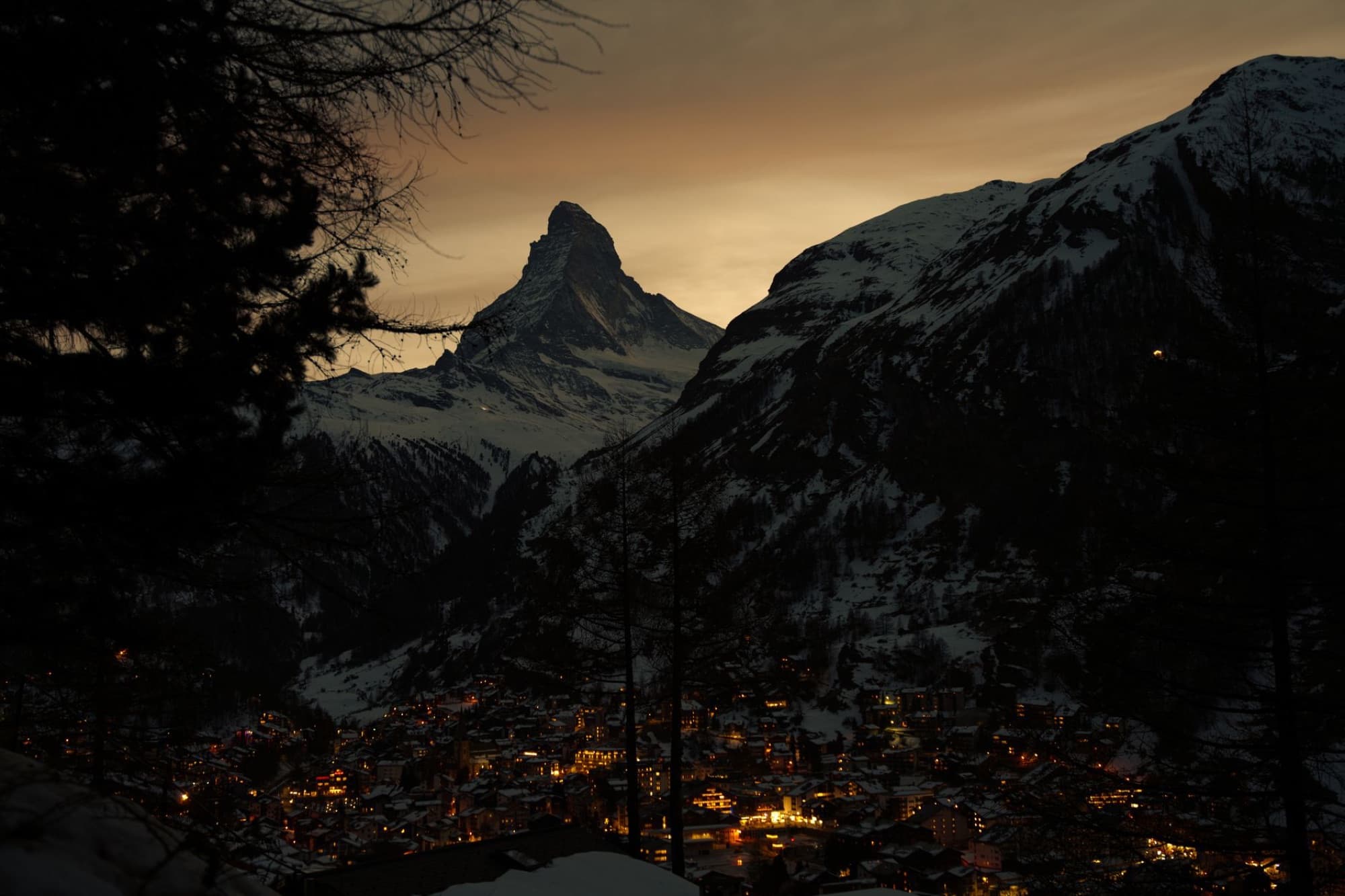 Breathtaking evening view of Zermatt with the iconic Matterhorn peak illuminated at sunset.