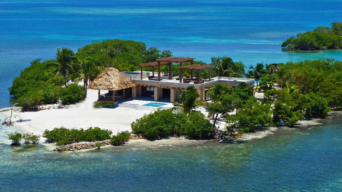 Private-island villa surrounded by shallow tropical water