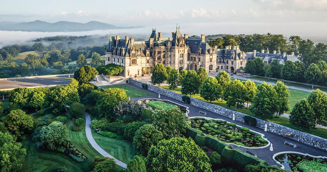 Grand château estate with formal gardens at dawn